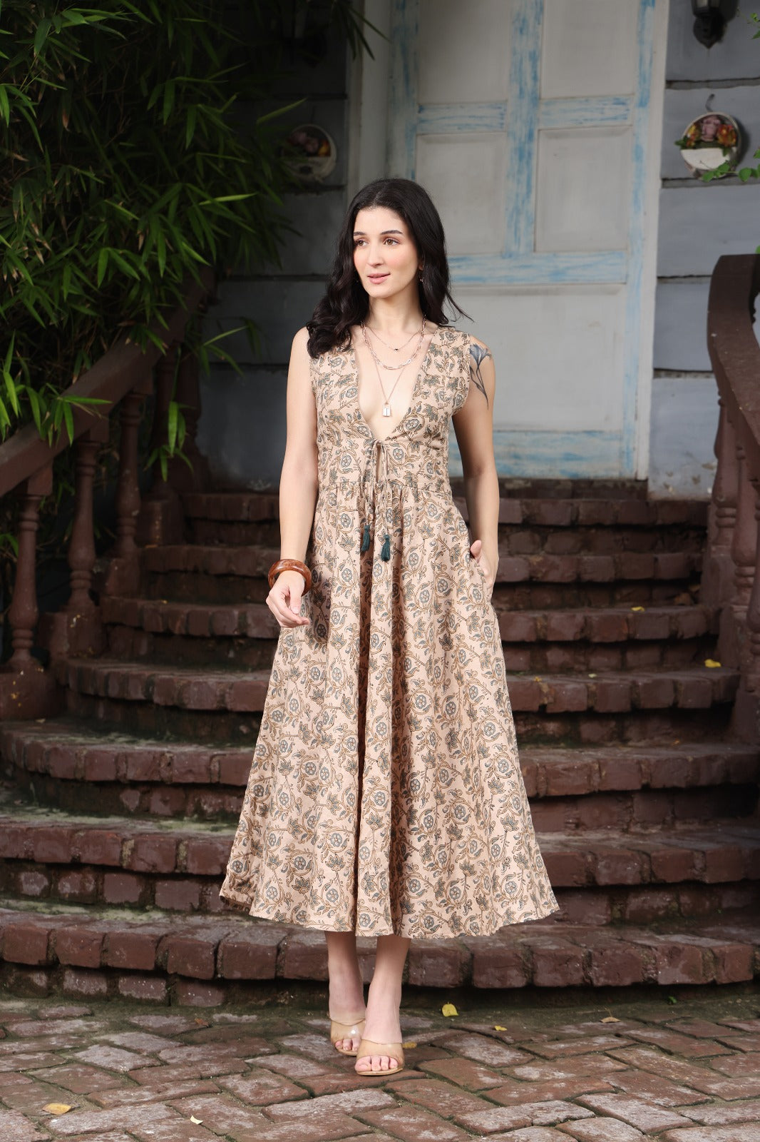 Beige linen maxi dress with deep V-neck and dori tassel tie-up, Indo-Western fusion style