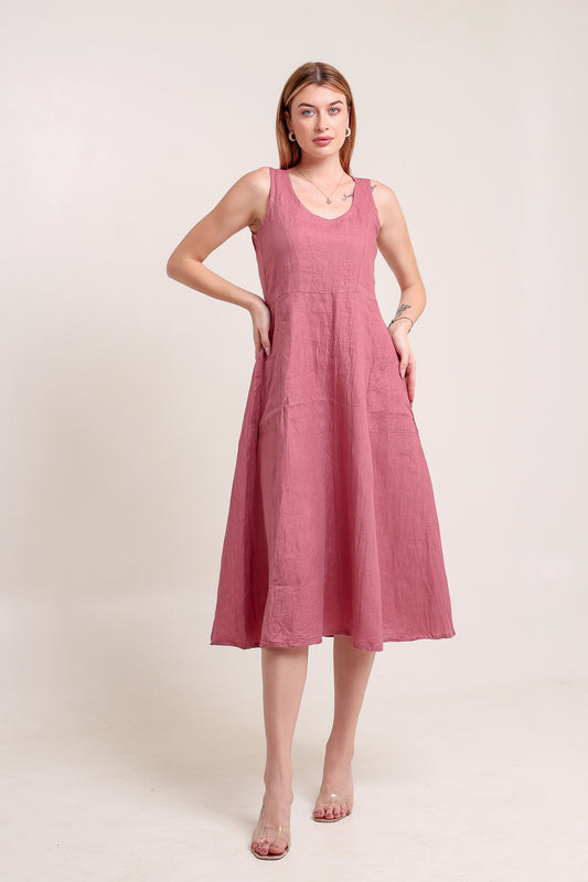Woman wearing a pink linen midi dress against a white background.